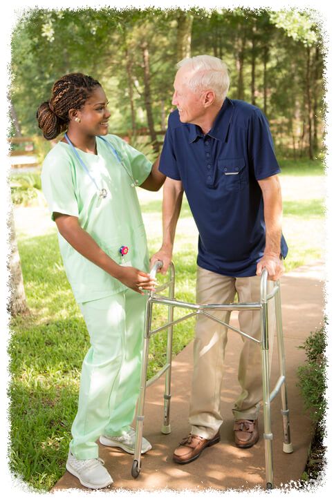 elderly man walking with assistant